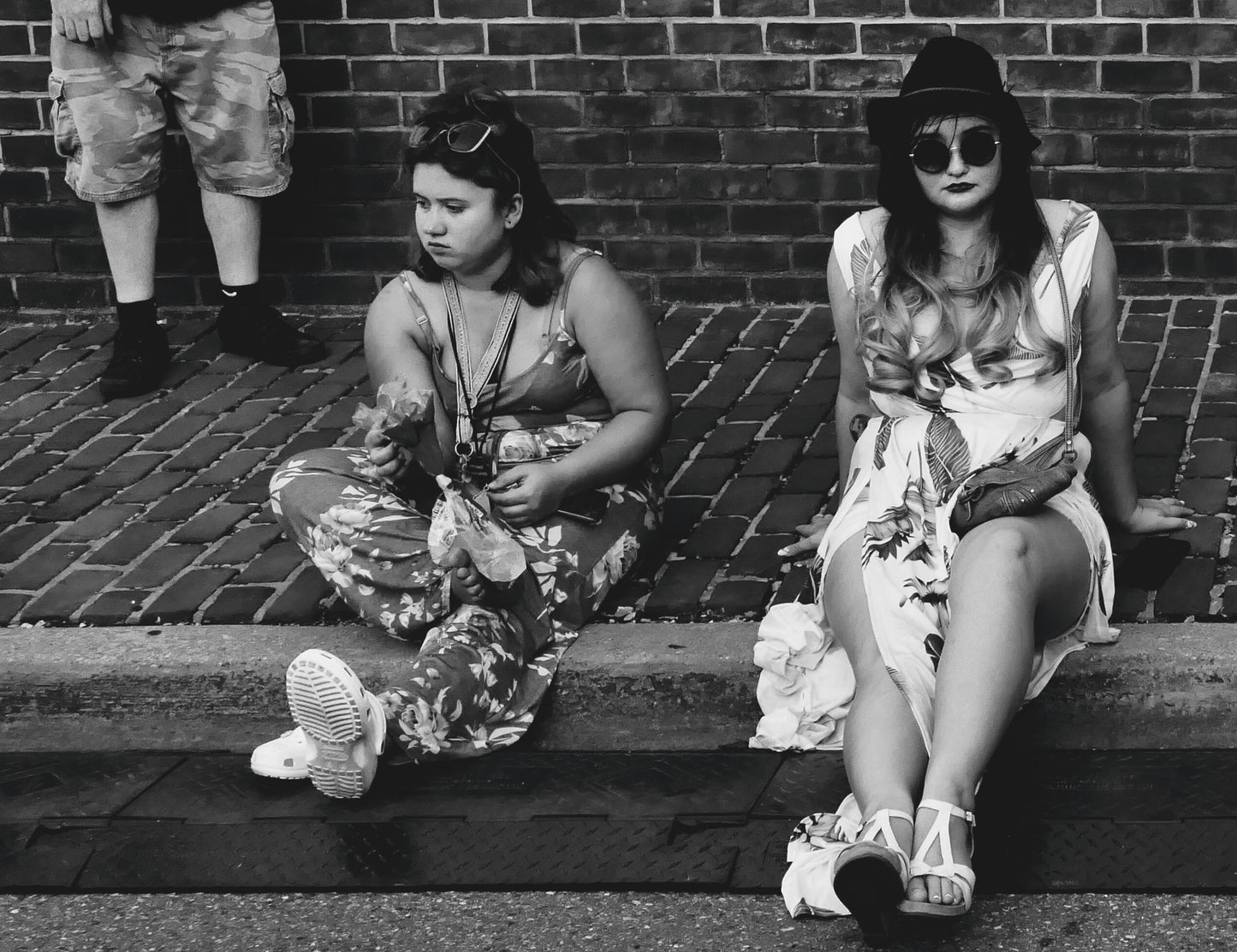 Two Girls Sitting on Sidewalk
