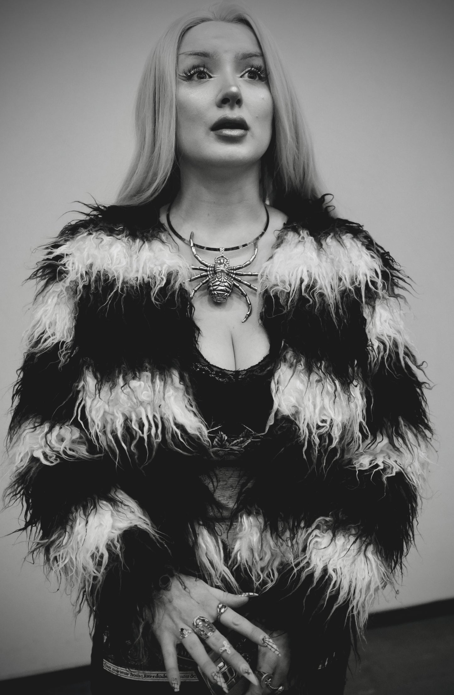 Woman in Black/White Fur with Spider Necklace