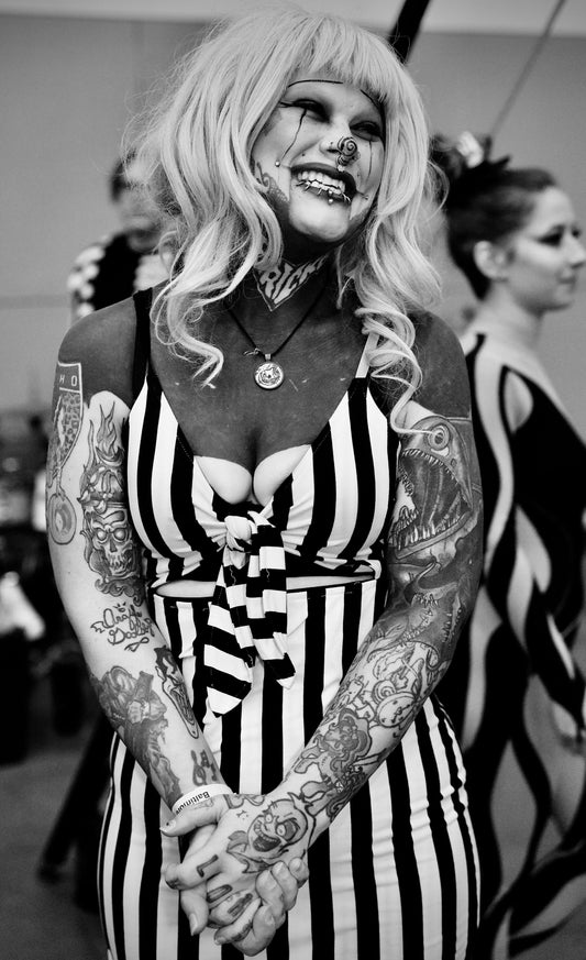Blonde with Black/White Striped Dress and Tattooed Arms