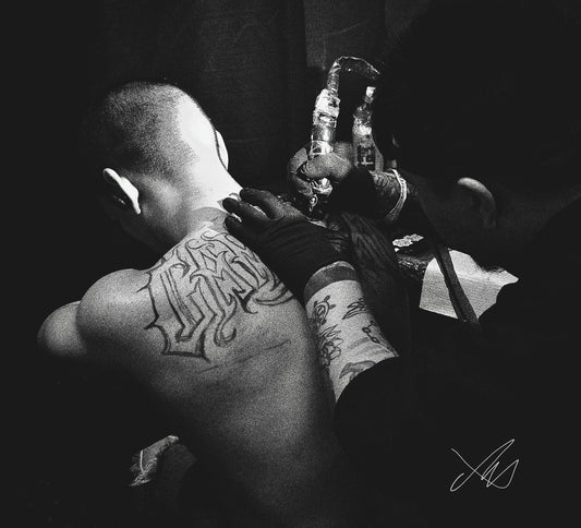 Tattoo Artist Working on Man's Back