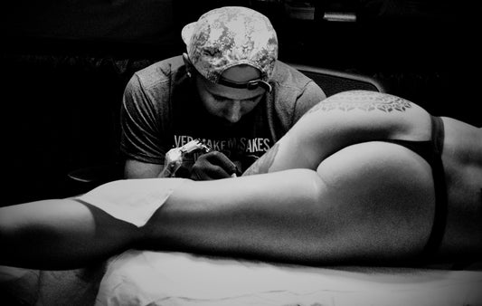 Tattoo Artist Working on Woman With Thong
