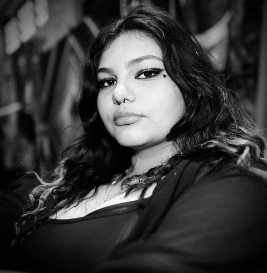 Dark Haired Young Woman With Nose Piercing and Full Lips