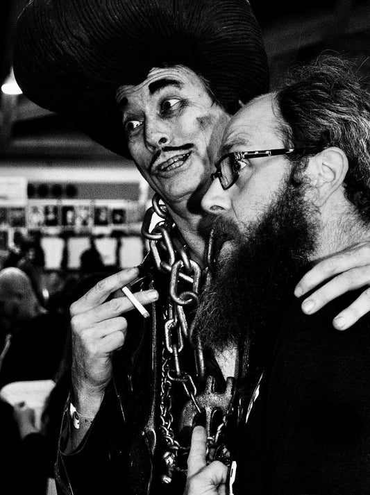 Man With Pencil Mustache and Neck Chain Holding Cigarette