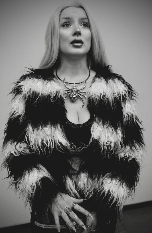 Woman in Black/White Fur with Spider Necklace