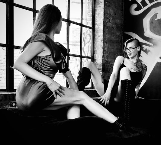 Two Women in Window Seat Looking at Each Other