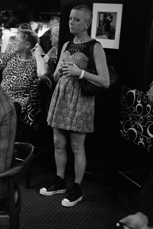 Forlorn Short-Haired Woman in Tennis Shoes