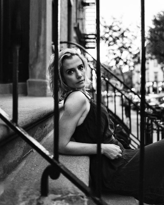 Blonde Woman on Steps Looking Through Railing
